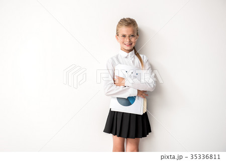 Cheerful child is posing against white wall 35336811
