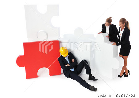 Coworkers look at tired foreman 35337753