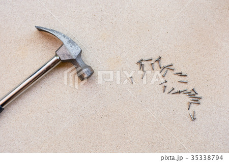 Hammer and nails on wood background 35338794