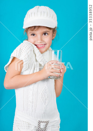 Beautiful little girl with glass of milk 35338952