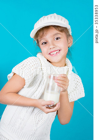 Beautiful little girl with glass of milk Beautiful little girl with glass of milk 35338953
