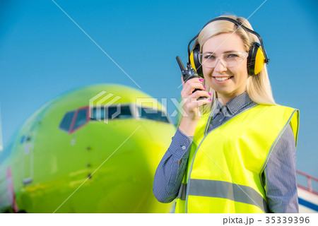 Airport worker with airplane on the background Airport worker with airplane on the background 35339396