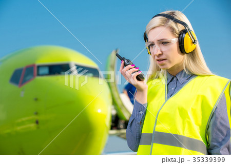 Airport worker with airplane on the background Airport worker with airplane on the background 35339399