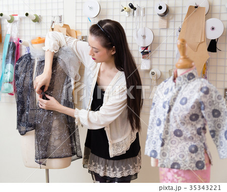 Fashion designer dressing a mannequin Fashion designer dressing a mannequin 35343221