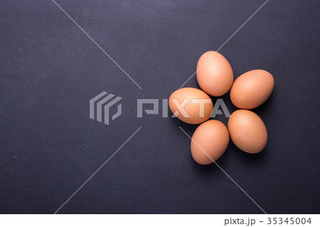 Fresh Eggs in bowl on black stone table background. Free space for text and design 35345004
