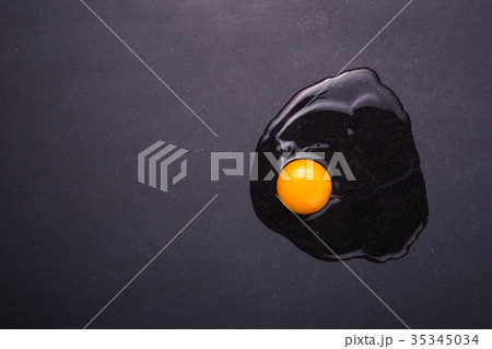 Broken eggs on the black stone ground. Free space for text and design. Top view 35345034