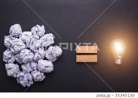 Top view crumpled paper and light bulbs on black stone board. Create idea concept 35345130