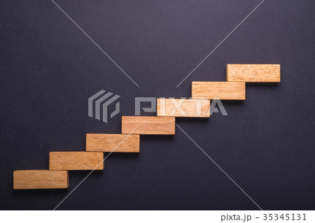 Wooden block set up for staircase on black stone board. Business concept for growth success process. Wooden block set up for staircase on black stone board. Business concept for growth success process. 35345131
