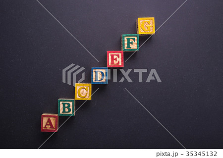 Education concept. A-G Colorful wood alphabet blocks on black stone board background 35345132