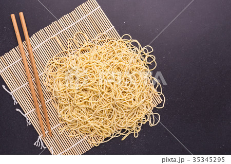 Traditional Thai yellow noodle on black stone table background 35345295
