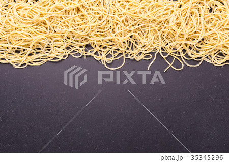Traditional Thai yellow noodle on black stone table background 35345296