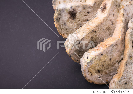 Mold on bread put on black stone table . Top view Mold on bread put on black stone table . Top view 35345313