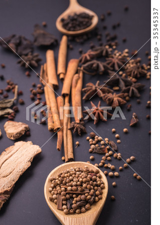 Mix of dried spices and herb on black stone table Mix of dried spices and herb on black stone table 35345337