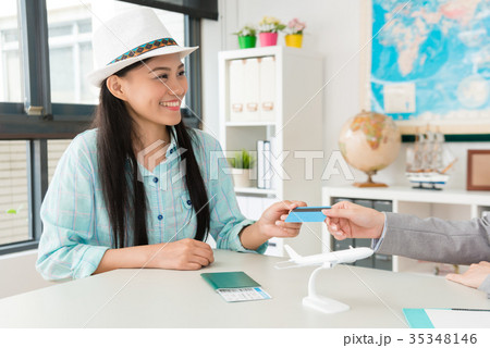 smiling pretty woman traveler giving credit card 35348146