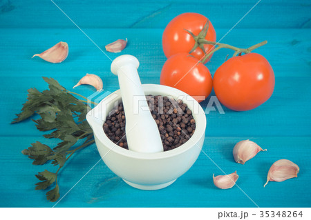 Black pepper in mortar and vegetables on boards 35348264