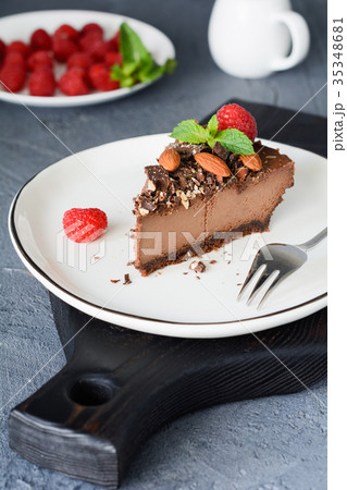 Slice of chocolate cheesecake with raspberries 35348681