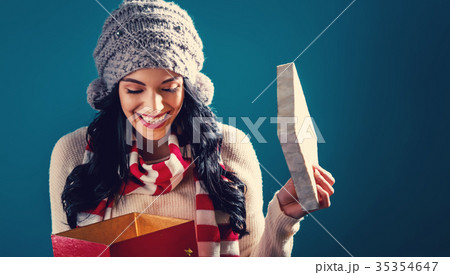 Happy young woman with Christmas present box 35354647