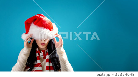 Woman with Santa hat pulled over her eyes 35354648