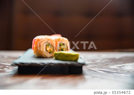 Rainbow sushi roll with wasabi on tray close up 35354672