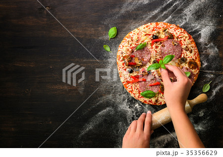 Girl hands making, decopating, preparing pizza 35356629