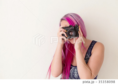 photographer girl with pink hair on a photo shoot photographer girl with pink hair on a photo shoot 35358098
