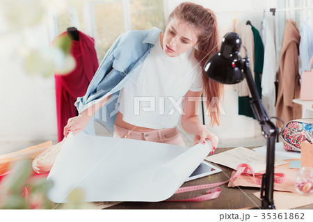 Fashion designers working in studio sitting on the 35361862