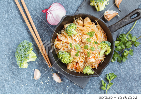 Fried vegan rice noodles with tofu and broccoli Fried vegan rice noodles with tofu and broccoli 35362552