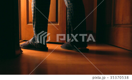 Adult man walks to a bathroom at the night 35370538