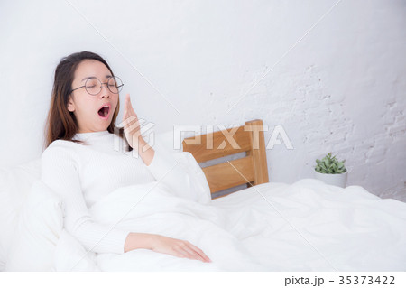 Beautiful asian woman waking up and yawn in bed. Beautiful asian woman waking up and yawn in bed. 35373422