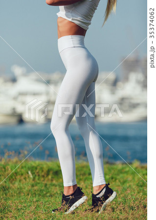 Legs of a sexy girl in white leggings. Mock-up. - Stock Photo