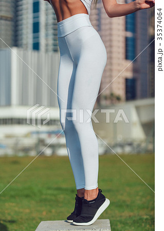 Legs of a sexy girl in white leggings. Mock-up - Stock Photo