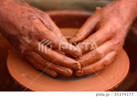 Potter making ceramic pot on the pottery wheel 35374177