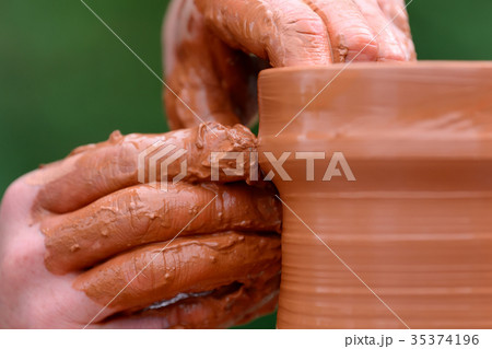 Potter making ceramic pot on the pottery wheel 35374196
