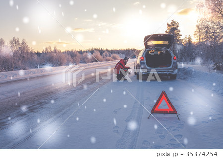 Broken car on a snowy winter road 35374254