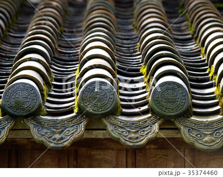 retro roof tiles and decorative ornaments closeup  35374460