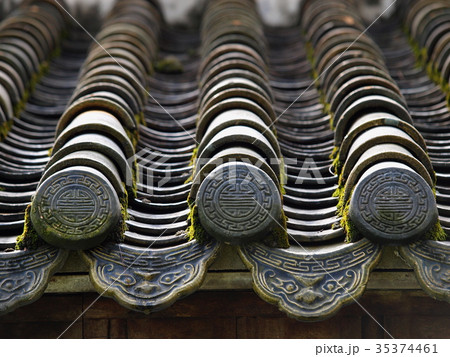 retro roof tiles and decorative ornaments closeup  35374461