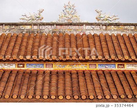 retro roof tiles and decorative ornaments closeup  35374464