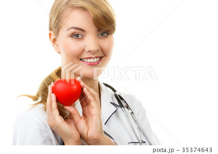 Woman doctor with stethoscope holding red heart Woman doctor with stethoscope holding red heart 35374643