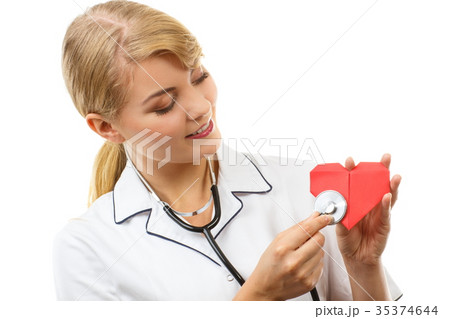 Woman doctor with stethoscope examining red heart 35374644
