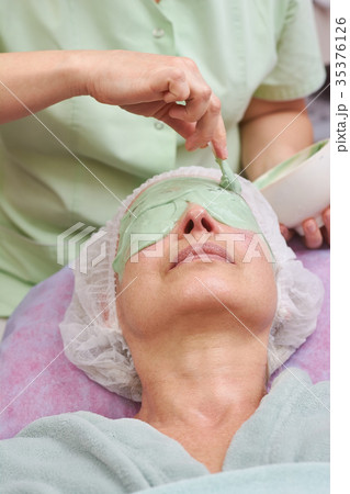 Mature woman, alginate face mask. Mature woman, alginate face mask. 35376126