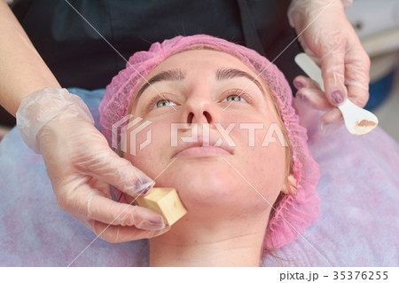 Hand applying foundation close up. Hand applying foundation close up. 35376255