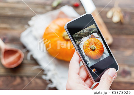 Woman shooting fresh orange pumpkin 35378029