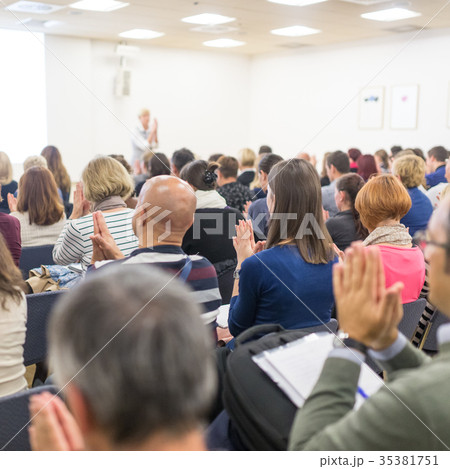 Woman giving interactive motivational speech at 35381751