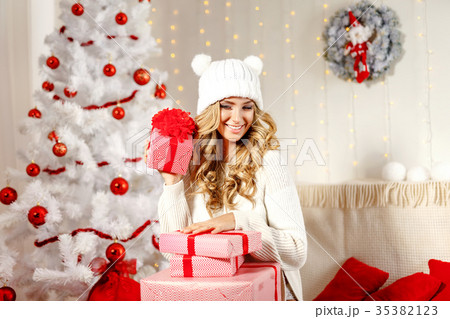 Charming model posing with Christmas presents Charming model posing with Christmas presents 35382123
