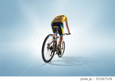 The bicyclist on gray, studio shot. The bicyclist on gray, studio shot. 35387526