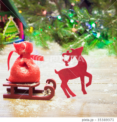 Christmas reindeer carries a sleigh on board. 35389371