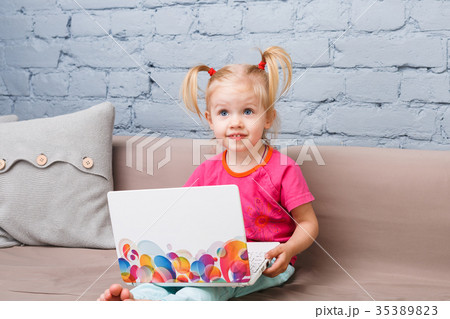 child girl three years old uses for training laptop computer 35389823
