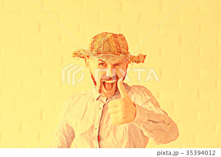 cheerful guy with a mustache in a straw hat cheerful guy with a mustache in a straw hat 35394012