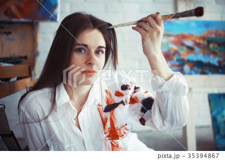 Young artist girl at work in the workshop brush paints canvas inspiration 35394867