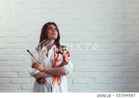 Young artist girl at work in the workshop brush paints canvas inspiration 35394997